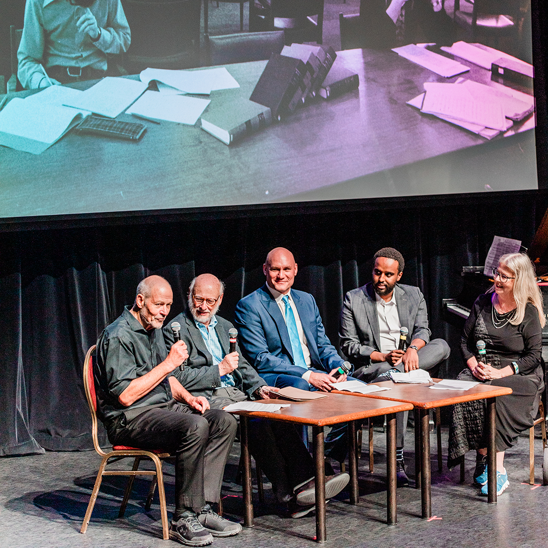 Professors on stage during the Here and Now sketch